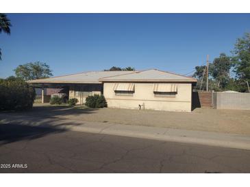 Charming single-story home featuring a classic desert landscape with an attached carport and awning-shaded windows at 4613 N 24Th Pl, Phoenix, AZ 85016
