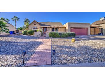 Charming single-story home features a well-manicured desert front yard, covered entry and two car garage at 538 E Rockwood Dr, Phoenix, AZ 85024