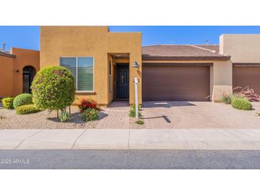 Charming single-story home featuring a well-maintained front yard and a two-car garage at 720 E Cobble Stone Dr, Queen Creek, AZ 85140