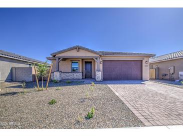 Charming single-story home featuring a desert landscape, neutral color palette, and a two-car garage at 17803 W Elm St, Goodyear, AZ 85395