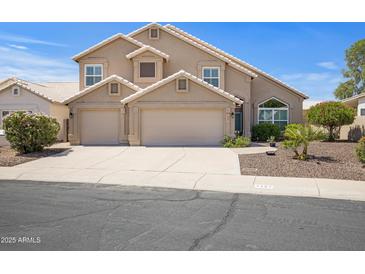 Charming two-story home featuring a three-car garage and desert landscaping at 4207 E Rockledge Rd, Phoenix, AZ 85044