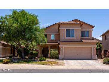 Charming two-story home with a well-maintained front yard and attached two-car garage at 44175 W Knauss Dr, Maricopa, AZ 85138