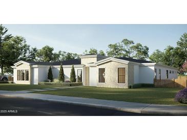 Modern home exterior with stone accents, manicured landscaping, and a well-maintained lawn at 5620 S Gemstone Dr, Chandler, AZ 85249