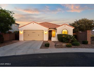 Charming single-story home featuring a tile roof, a two-car garage, and a beautifully landscaped front yard at 7973 S Peppertree Ct, Gilbert, AZ 85298