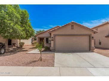 Charming single-Gathering home featuring a two-car garage, desert landscaping and mature shade tree at 12109 N 127Th Dr, El Mirage, AZ 85335