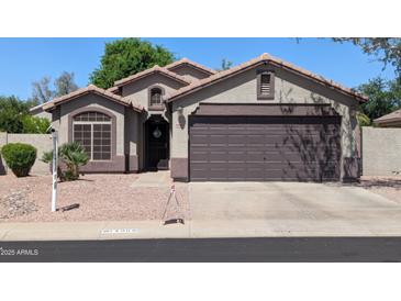 Charming single-story home with a two-car garage and desert landscaping at 14968 N 134Th Ln, Surprise, AZ 85379