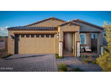 Charming single-story home with a desert landscape, brick driveway, and covered front porch, perfect for relaxing outdoors at 3610 E Peralta Canyon Ln, San Tan Valley, AZ 85140