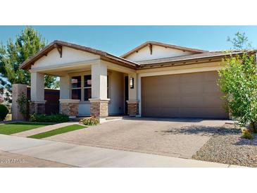 Charming single-story home featuring a two-car garage, covered entry and well-maintained landscaping at 3877 E Oxford Ln, Gilbert, AZ 85295