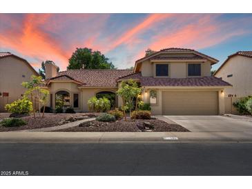 Charming two-story home featuring a well-manicured front yard and a spacious two-car garage at 401 N Cholla St, Chandler, AZ 85224