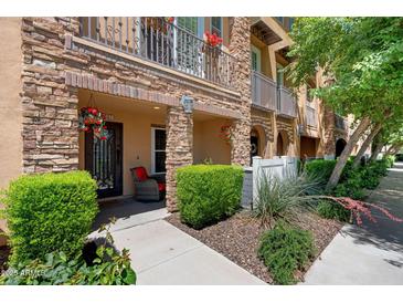 Charming townhome featuring stone accents, iron railings, and lush landscaping at 4347 N 24Th Way, Phoenix, AZ 85016