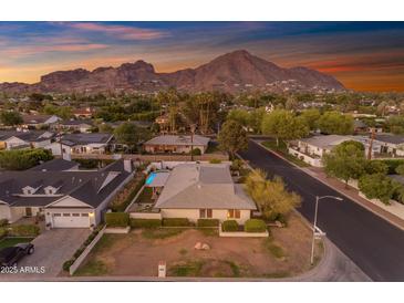 Inviting single-story home featuring an attached garage and stunning mountain views at sunset at 4596 E Calle Ventura --, Phoenix, AZ 85018