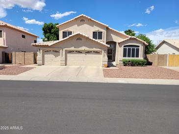 Charming two-story home featuring a three-car garage, manicured landscaping, and a neutral color palette at 4746 W Taro Dr, Glendale, AZ 85308