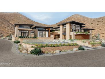 Stunning multi-level home with a sparkling pool, stone accents, and views of the desert landscape at 7900 E Crisscross Way, Cave Creek, AZ 85331