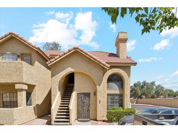 Charming two-story condo features desert landscaping, a tile roof, and arched entry stairs at 1126 W Elliot Rd # 1066, Chandler, AZ 85224