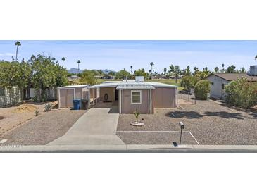 Charming home with a low-maintenance yard and a private driveway at 1707 S 72Nd St, Mesa, AZ 85209