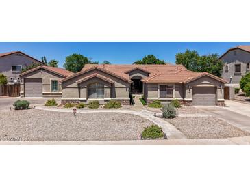 Charming single-story home featuring a well-maintained landscape and a spacious driveway at 3060 E Hope St, Mesa, AZ 85213