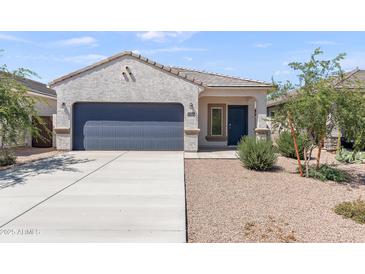 Charming single-story home featuring a stucco facade, desert landscaping, and a two-car garage at 35266 W San Sisto Ave, Maricopa, AZ 85138