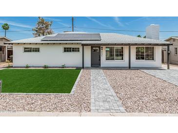 Charming home featuring a neatly manicured lawn and stylish walkway leading to the front door at 4531 N 12Th Dr, Phoenix, AZ 85013