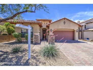 Inviting home featuring mature landscaping, a tile roof, and a large driveway at 6941 E Snowdon St, Mesa, AZ 85207