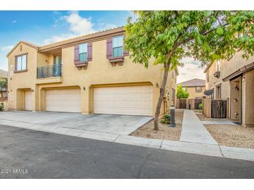 Exterior shot of building with two garages, balcony, and nice landscaping at 8113 W Groom Creek Rd, Phoenix, AZ 85043