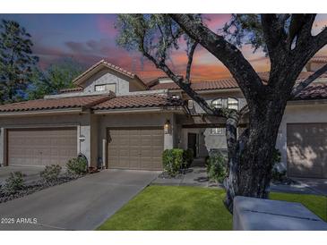 Charming two-story home featuring a brown tile roof, stucco walls, and two-car garage at 9705 E Mountain View Rd # 1096, Scottsdale, AZ 85258