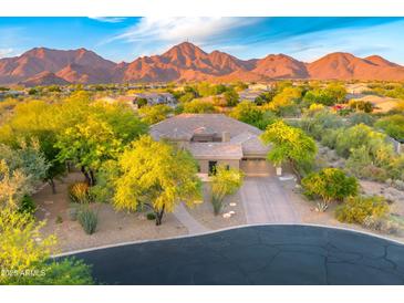 Beautiful single-Gathering home with desert landscaping and a majestic mountain backdrop at sunset at 10694 E Redfield Rd, Scottsdale, AZ 85255