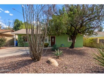 Charming green ranch-style home with desert landscaping and mature trees in a peaceful neighborhood at 2231 E Weldon Ave, Phoenix, AZ 85016