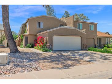 Charming two-story home featuring a two-car garage and mature landscaping at 2941 E Nisbet Ct, Phoenix, AZ 85032