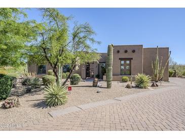 Attractive desert-style home with native landscaping, mature trees, and a brick-paved driveway at 4772 E Agave Ln, Cave Creek, AZ 85331