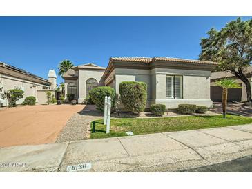 Charming single-story home featuring desert landscaping and a neutral color scheme under a clear blue sky at 8136 E Cortez Dr, Scottsdale, AZ 85260
