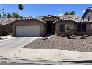 Charming single story home with desert landscaping, tile roof, and inviting curb appeal in a warm, sunny setting at 1314 S Larkspur St, Gilbert, AZ 85296