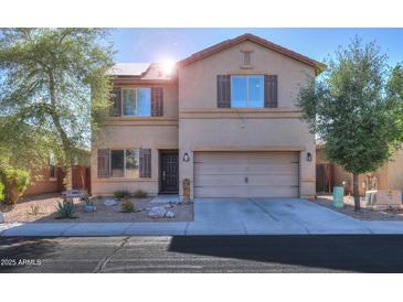 Two-story home featuring a neat front yard, neutral colors, and an attached two-car garage at 18586 N Lariat Rd, Maricopa, AZ 85138