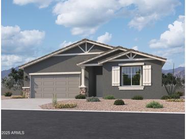 Charming single-story home featuring a two-car garage, neutral paint, and decorative stone accents at 24113 W Bowker St, Buckeye, AZ 85326