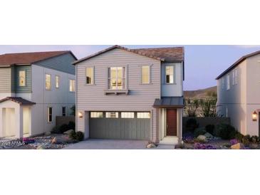 Charming two-story home with a neutral color palette, a gray garage door, and a cozy front porch at 2486 W Rowel Rd, Phoenix, AZ 85085