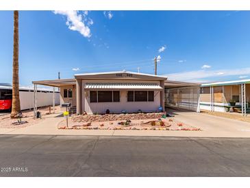 Charming single-story home with well-maintained landscaping and covered parking on a sunny day at 2700 E Allred Ave # R87, Mesa, AZ 85204