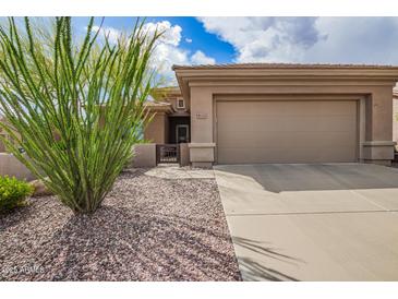 Exterior elevation of home showcasing the front yard, garage and desert landscaping at 41202 N Rolling Green Way, Anthem, AZ 85086