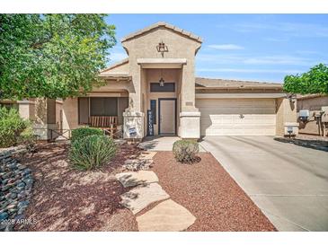 Charming single-story home with a well-manicured front yard and inviting entryway at 4232 S 103Rd Ln, Tolleson, AZ 85353