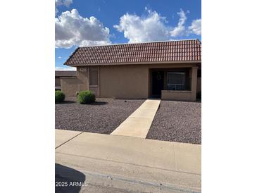 Charming single-story home featuring well-kept landscaping, sidewalk and classic desert design at 426 W Pontiac W Dr # 4, Phoenix, AZ 85027