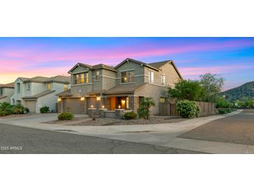 Beautiful two-story home with a three-car garage, stone accents, and professional landscaping at 5231 W Desperado Way, Phoenix, AZ 85083