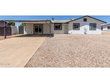 Charming single-story home with a xeriscaped front yard and covered parking at 632 N 95Th St, Mesa, AZ 85207