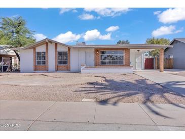 Charming single-story home featuring brick accents and a low-maintenance gravel front yard at 7614 W Cheery Lynn Rd, Phoenix, AZ 85033