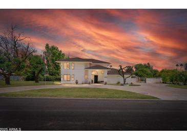Stunning home with manicured lawn, mature trees, circular driveway, and fountain at 10532 W Catalina Dr, Avondale, AZ 85392