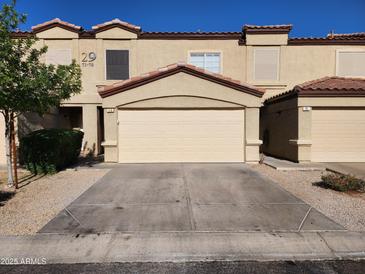 Charming townhome featuring a two-car garage, desert landscaping and a tile roof at 125 S 56Th St # 75, Mesa, AZ 85206