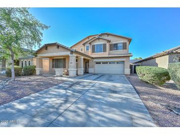Charming two-story home with a covered porch and a two-car garage and low maintenance landscaping at 16112 W Durango St, Goodyear, AZ 85338