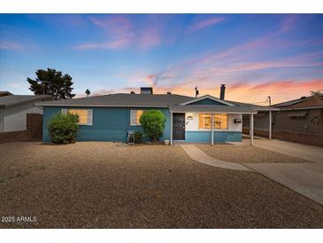 Charming single story home with manicured landscaping and inviting curb appeal at dusk at 2144 W 1St Pl, Mesa, AZ 85201