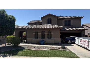 Elegant two-story home featuring a tile roof, arched windows, and well-maintained landscaping in a suburban setting at 2670 S Dragoon Dr, Chandler, AZ 85286