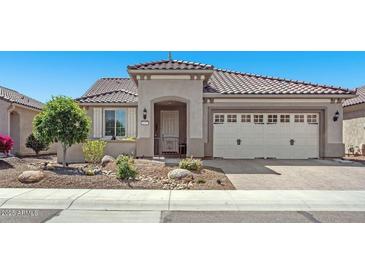 Charming home featuring desert landscaping, a tile roof, and an attached two-car garage at 26915 W Piute Ave, Buckeye, AZ 85396