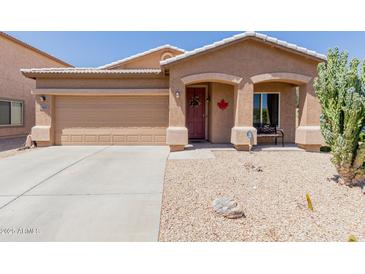 Charming single story home with a two car garage, neutral colored stucco, and xeriscaping for low maintenance at 28834 N Spur Dr, San Tan Valley, AZ 85143
