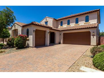 Inviting two-story home featuring a three-car garage, brick driveway and well-manicured landscaping at 3796 E Rakestraw Ln, Gilbert, AZ 85298