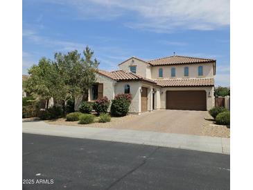 Charming two-story home featuring a tile roof and a well-manicured front yard with beautiful shrubbery at 3796 E Rakestraw Ln, Gilbert, AZ 85298